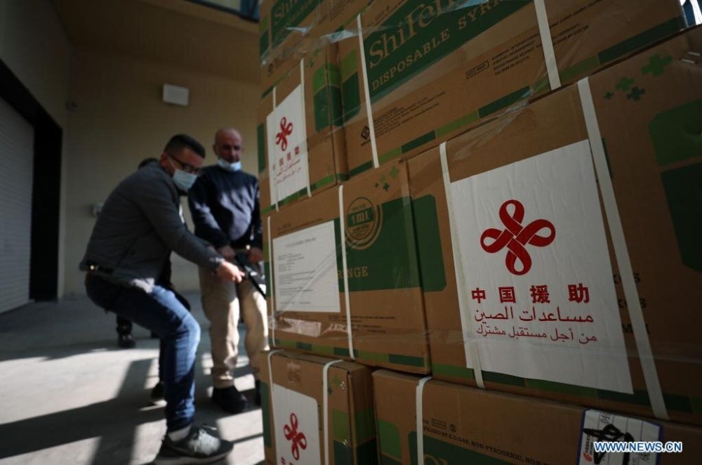 Workers unload a donated shipment of Chinese Sinopharm vaccines in the West Bank city of Nablus. [Photo by Ayman Nobani/Xinhua]